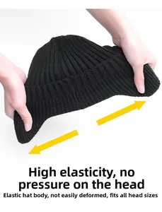 Close-up of highly elastic black ribbed beanie showing stretchability and knitted texture
