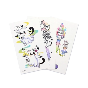 Glow-in-the-dark Halloween temporary tattoos featuring cute blue luminous cats and ghosts