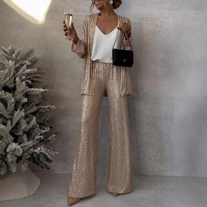 Close-up of golden sequin blazer and high-waisted trousers for festive party wear