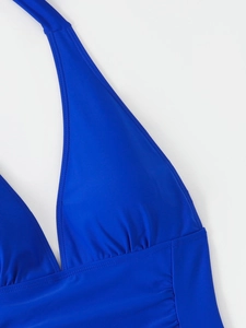Detail of royal blue halter swimsuit showing ruching texture and double stitching