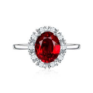 Elegant silver ring featuring a large oval red ruby center stone with a diamond halo