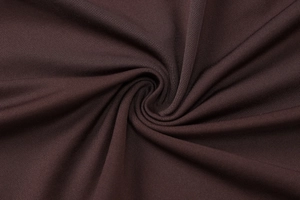 Detailed view of dark brown knitted fabric with fine vertical stripes and soft texture