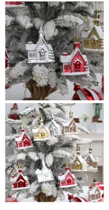 Detail of multi-colored Christmas house ornaments with snow effect on white tree