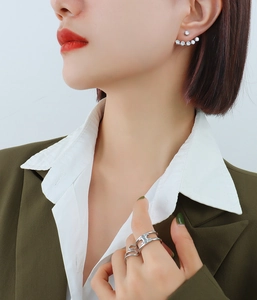 Close-up of 18k gold plated earrings with zircon inlays and hollowed-out ring detail