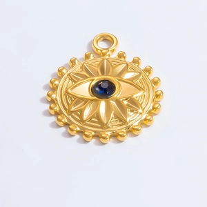 Detailed view of evil eye sunburst pendant in gold finish with a deep blue gemstone