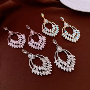 Macro detail of cascading rhinestone tassel earrings with crystal wheat ear design