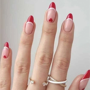 Valentine style French almond press-on nails with red heart patterns and white line accents