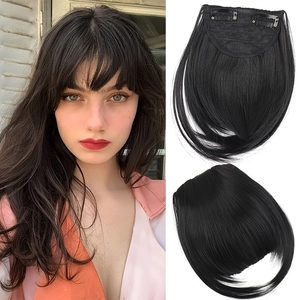 Detail view of black clip-in hair bangs with sideburns and secure metal clip fasteners