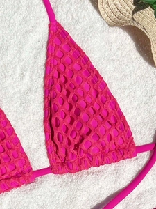 Detail of hot pink bikini top with 3D popcorn texture fabric and halter neck ties