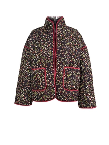 Detail of navy quilted jacket with red cherry floral print and piped edges