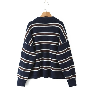 Detailed view of the navy, white and brown striped polo sweater with a ribbed hem