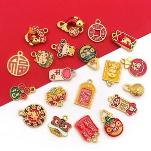 Close-up of enamel Chinese New Year charms featuring red and gold blessing characters