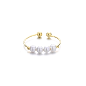 Adjustable golden twisted ring featuring four white pearls in a minimalist elegant style