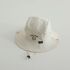 Detail of kids bucket hat featuring cartoon face embroidery and adjustable windproof cord