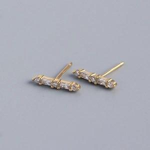 Detail of 925 sterling silver stamp on golden bar earrings with clear crystal stones