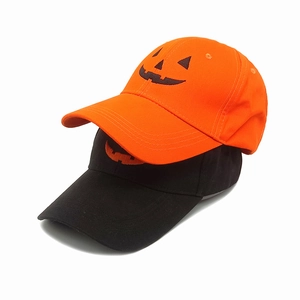 Halloween baseball caps in orange and black with pumpkin face embroidery on white background