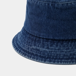 Close-up of deep blue denim bucket hat showing detailed twill fabric and reinforced stitching