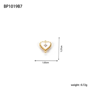 Detail of heart charm with white enamel, gold beaded edge and rhinestone, 1.27cm size