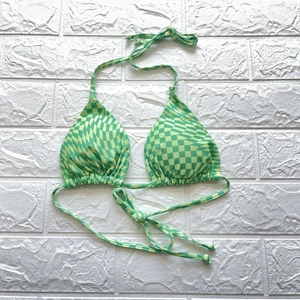 Detail eines grünen Bikini-Oberteils mit Schachbrettmuster und verstellbaren Trägern