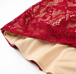 Vue détaillée de la dentelle rouge ajourée avec doublure beige et coutures de qualité