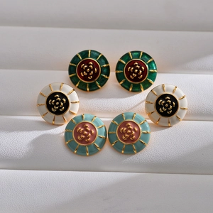 Three pairs of vintage enamel camellia earrings in gold-plated brass on a white base