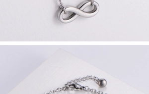 Macro detail of infinity pendant necklace with lobster clasp and adjustable silver chain