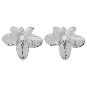 Detailed view of silver hammered flower earrings with white pearl centers for women