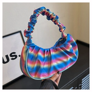 Detail of colorful gradient pleated dumpling bag with glossy finish and top handle