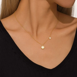 Detail of s925 silver flower necklace with white shell and zircon on a model