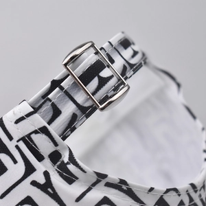 Close-up of the adjustable metal buckle on a stylish monogram L pattern baseball cap