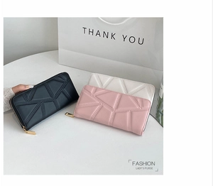 Detail of long PU leather wallets with geometric stitching and smooth zip closure