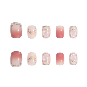 Handmade pink gradient press-on nails set with gold line details and peach accents