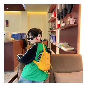 Dettaglio di un borsello giallo a forma di papera in tela per bambini in un bar accogliente