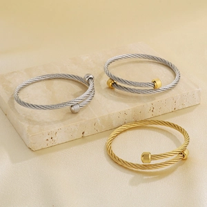 Three twisted cable bangles in gold and silver stainless steel with screw end caps