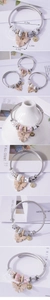 Detail view of steel wire bracelet with pearl butterfly pendant and size measurements