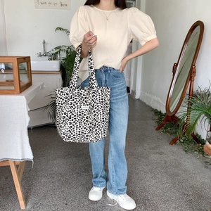 Fashionable leopard print canvas tote bag styled in a minimalist lifestyle setting