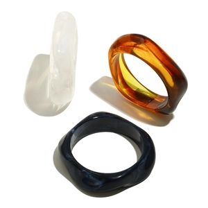 Three-piece set of thick pentagonal acrylic bangles in white, amber, and deep blue