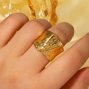 Golden wide band stainless steel ring with elegant irregular pleated texture and glossy finish