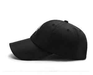 Side view of a black quick-dry baseball cap with a curved brim and a six-panel structure