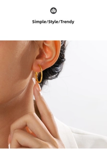 Close-up of polished 18K gold-plated stainless steel hoop earring on a female model