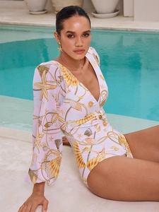 Detail of long sleeve swimsuit with starfish print, deep V-neck and waist buckle