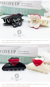 Detail view of 8.3cm hair claw clips in black and cream with red heart accents