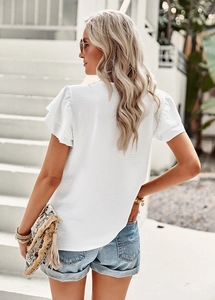 Rear view of a white short-sleeved blouse featuring ruffle sleeves and a textured fabric finish