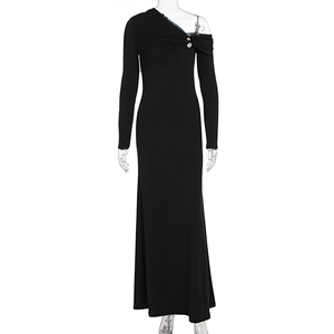 Detail of elegant black one-shoulder knit dress with pleated bodice and button accent