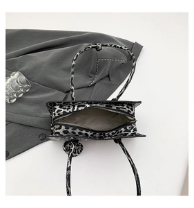 Top view of leopard print handbag showing smooth zipper closure and textured material