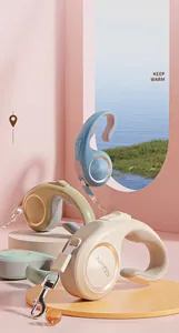 Close-up of ergonomic ring-shaped handles on retractable pet leashes in Morandi colors