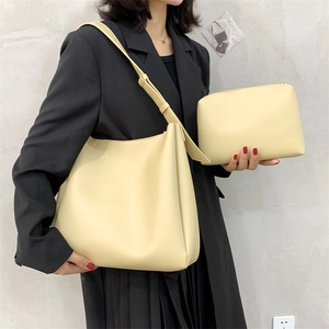 Minimalist cream yellow tote bag set with a matching pouch and a smooth faux leather finish