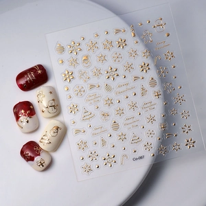 Detailed 3D embossed gold Christmas nail stickers with snowflake and reindeer patterns