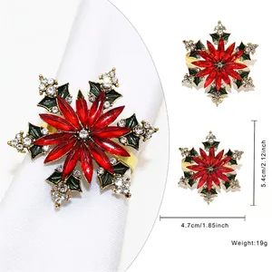 Antique gold snowflake napkin ring with red crystal petals and green enamel details