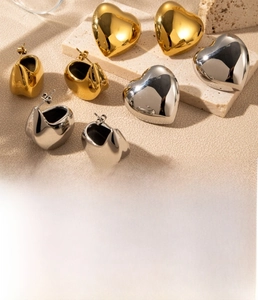Detail of heart-shaped titanium steel earrings with polished vacuum plated finish